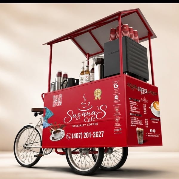 Red Susana’s Café specialty coffee cart with bicycle wheels, stacked cups, syrups, espresso equipment, and menu graphics.